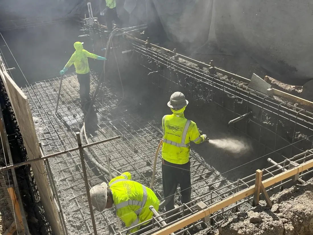 Granada Hills 1 Crew spraying gunite over rebar in a pool excavation