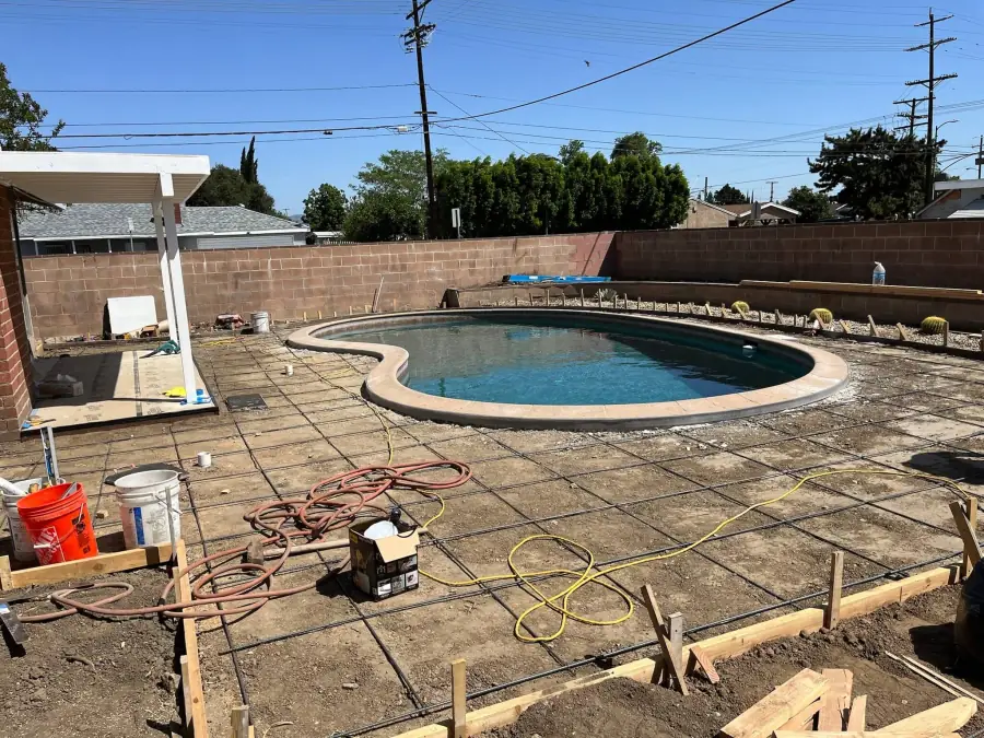 Concrete deck formed and reinforced around a pool during a North Hills remodel