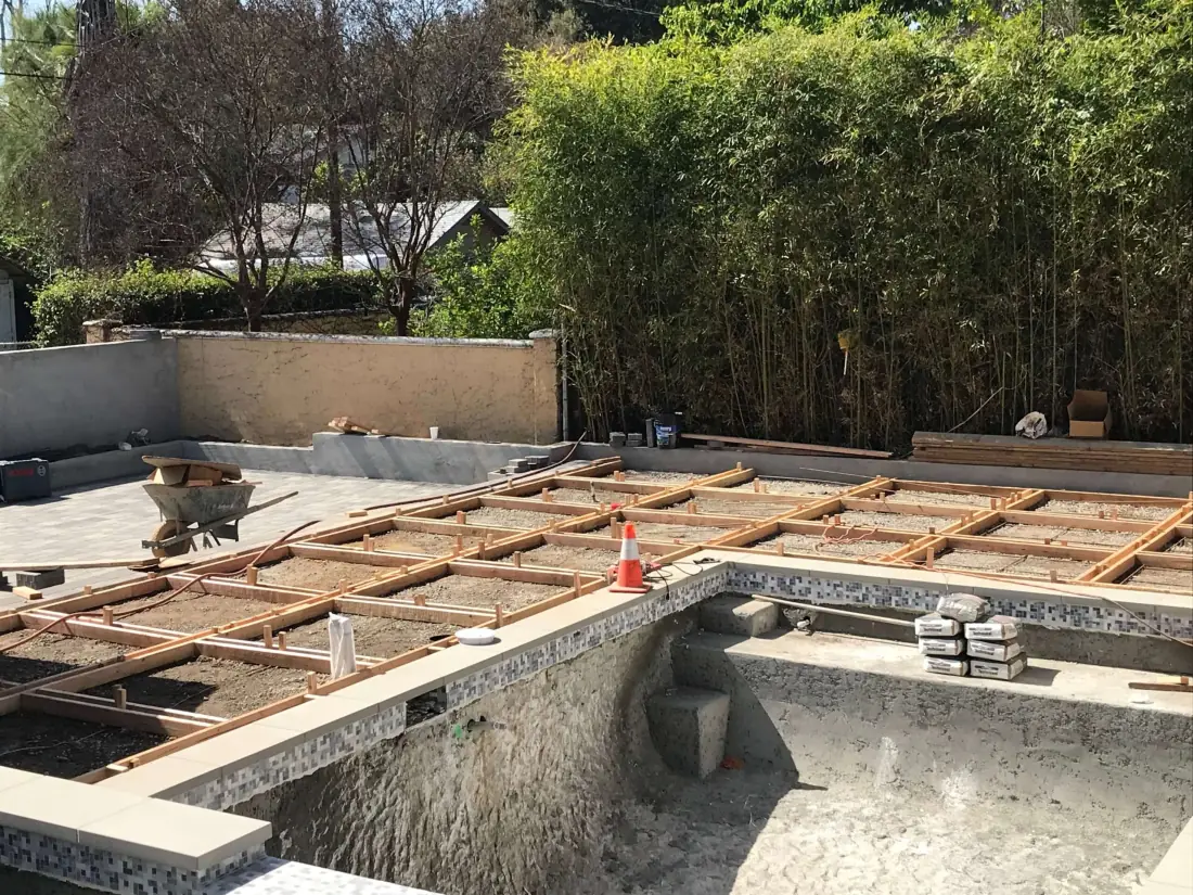 Pasadena 2 Deck framing and a stripped pool shell during a backyard remodel