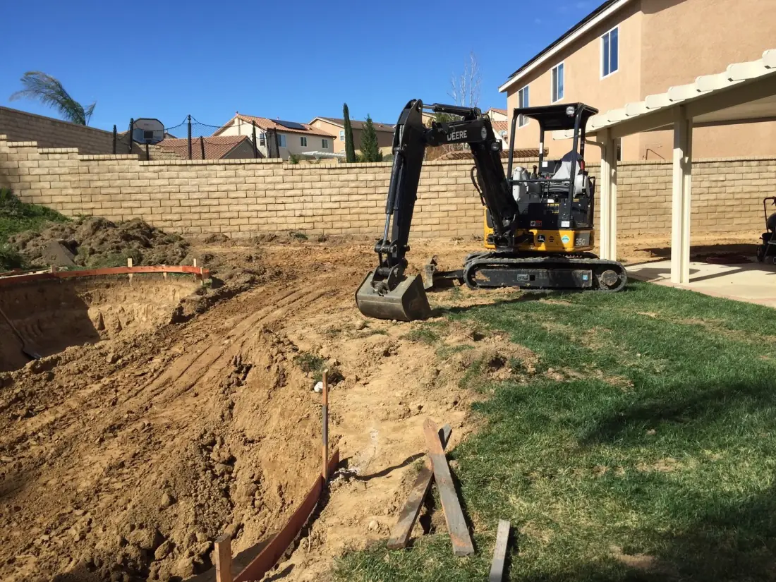Winnetka 2 Mini excavator digging a new pool in a backyard