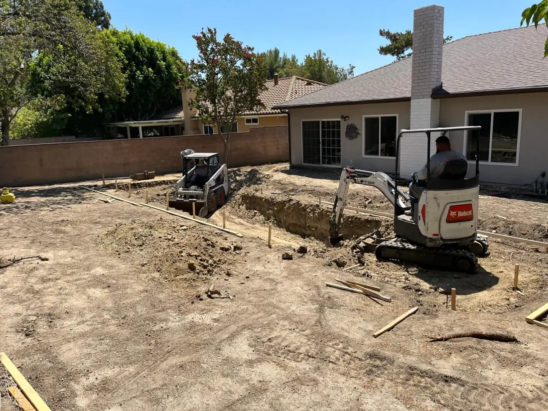 New Construction of Pools 1 Mini excavator digging a new pool in a flat backyard