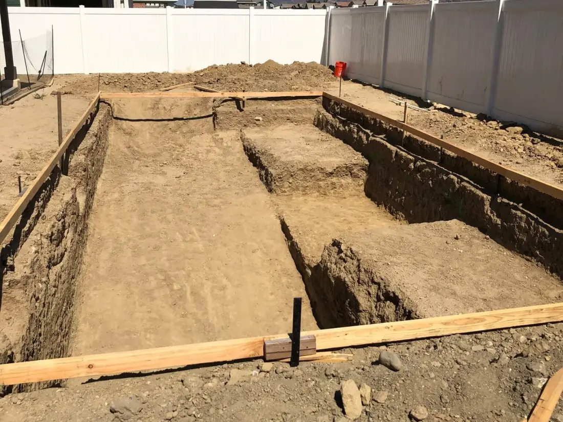 New pool excavation with the layout set in wood forms