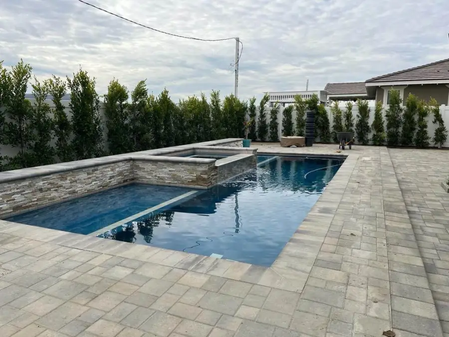 New rectangular pool and raised spa with a paver deck in Fillmore