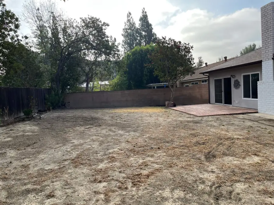 Bare dirt backyard in Granada Hills before a new pool was built