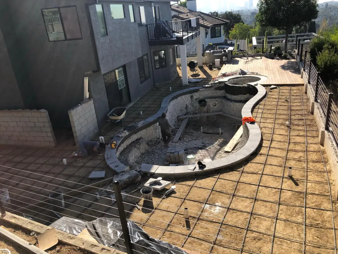 Glendale 2 Pool and spa shell with new coping, surrounded by deck rebar on a hillside lot