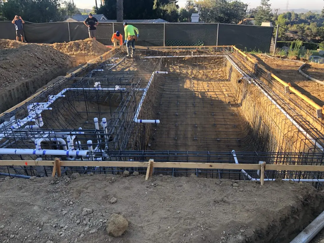 Pool Equipment 7 New white PVC pool plumbing lines run through the rebar of an excavated pool