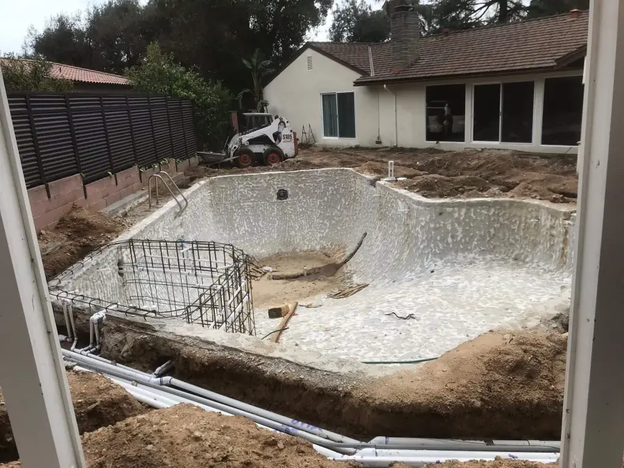 Old pool torn out to the shell before a full remodel in Altadena