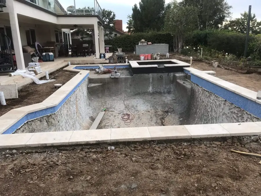 Los Angeles 1 Pool mid-renovation with new waterline tile and coping, bare shell ready for resurfacing