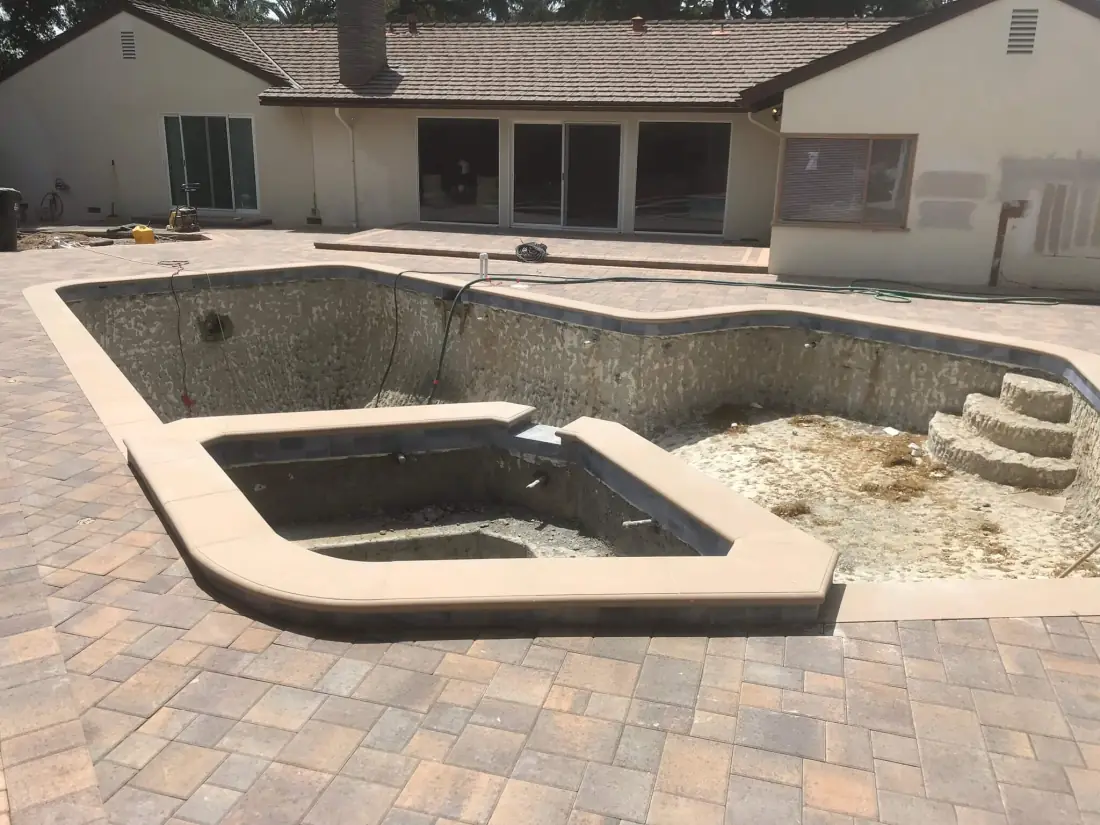 Altadena 2 Pool stripped for a remodel, with a new raised spa shell and coping set in a new paver deck