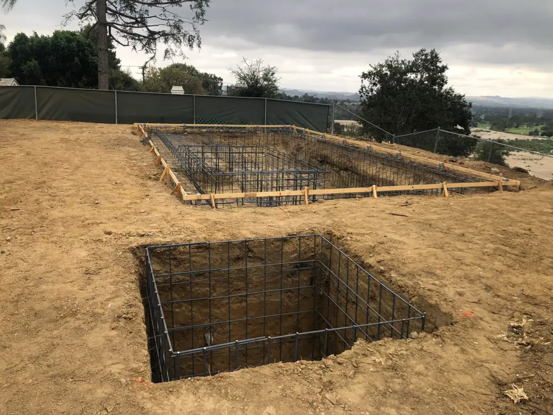 Rebar cages for a new pool and spa in a hillside excavation