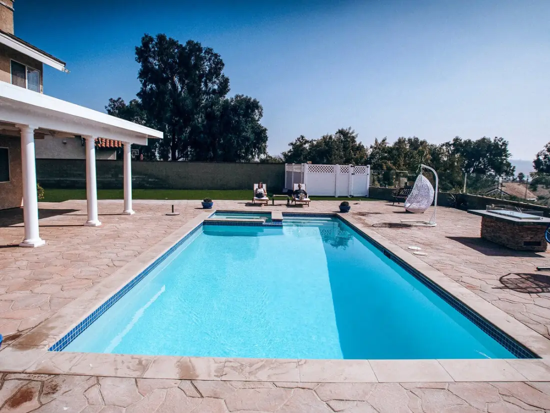 Canoga Park 1 Rectangular pool with a flagstone deck beside a covered patio
