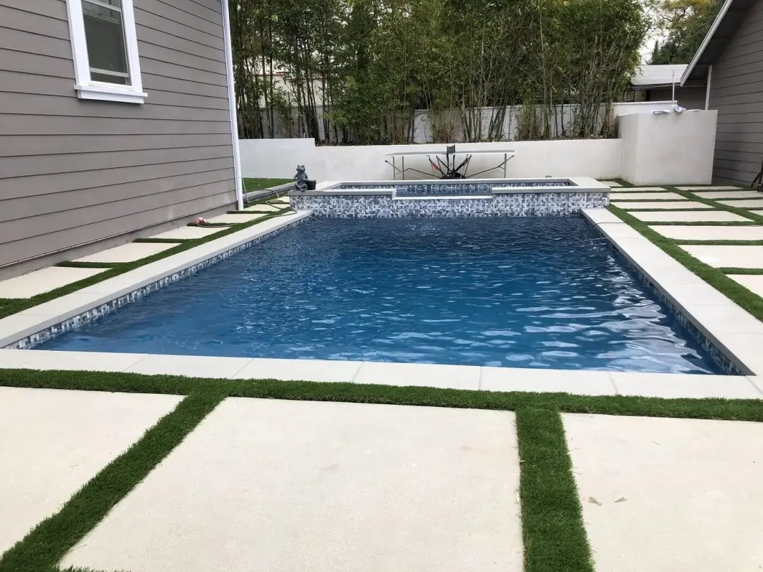 Lake Balboa 1 Rectangular pool with a glass tile waterline and concrete pavers set in turf