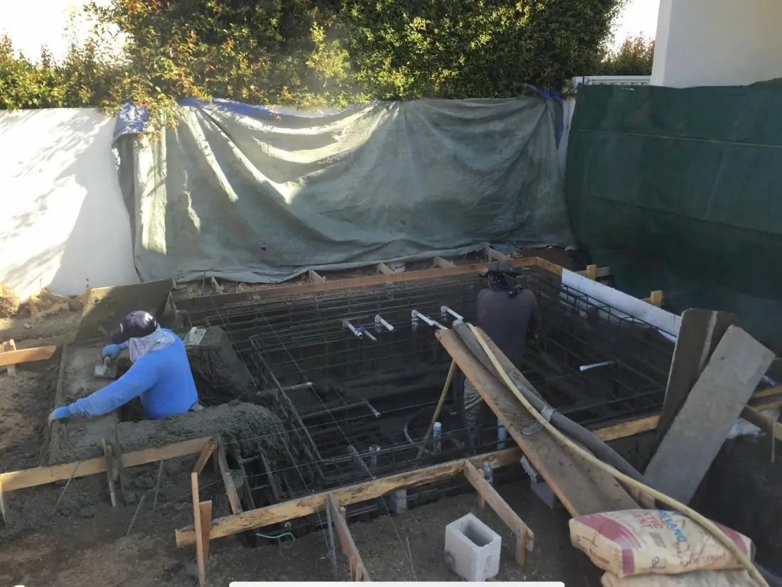 Studio City 2 Worker setting rebar and forms for a spa beside a house
